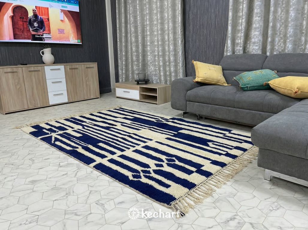 Large custom Beni Ourain area rug anchoring a modern living room with a neutral linen sofa, wooden coffee table, and bohemian decor accents.