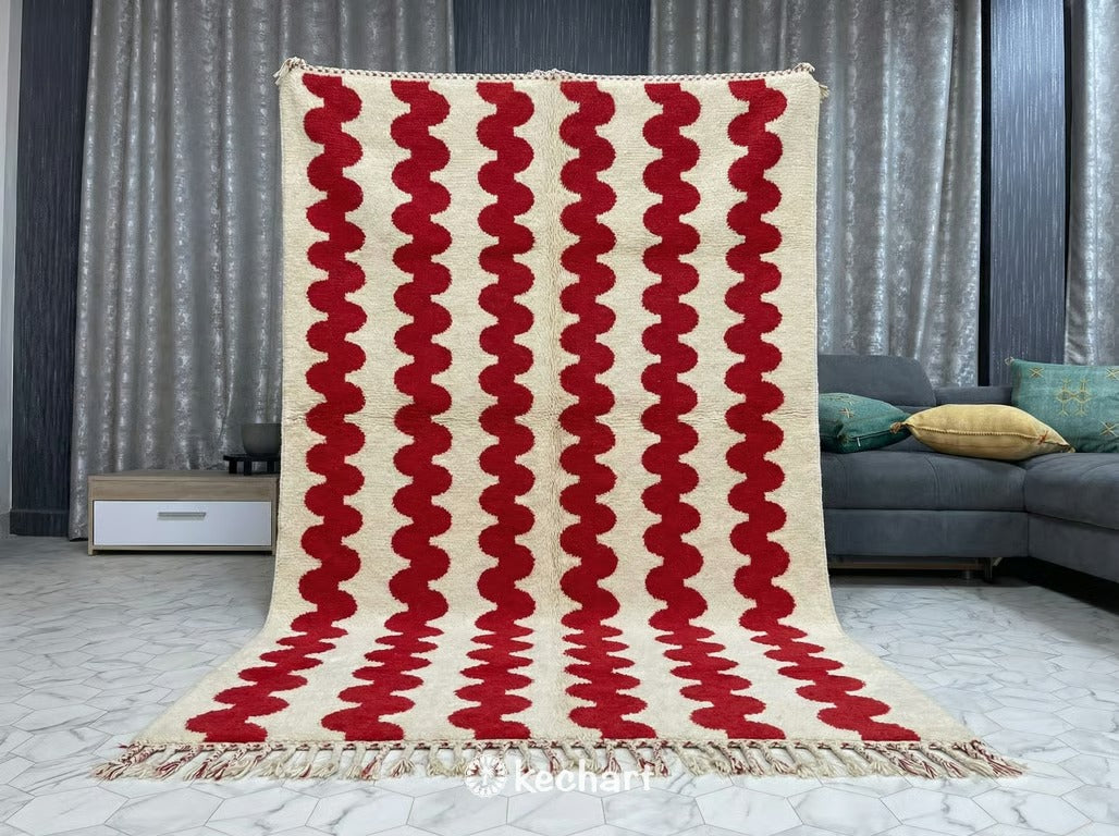 Close up view showing the thick, shaggy wool pile texture of the custom cream Beni Ourain rug and the vibrant red diamond details.
