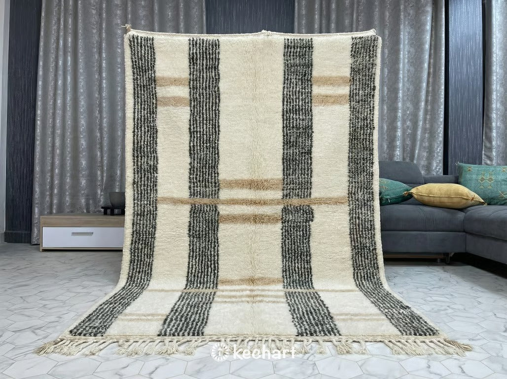 Detail shot highlighting the deep, shaggy wool pile and hand-knotted construction of the custom Moroccan rug, showing the variation in the natural soft white and greige yarn.