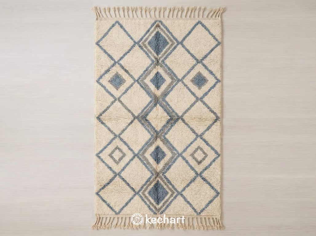 Custom made Beni Ourain Moroccan wool rug flat lay featuring organic flowing lines in dusty blue grey and cool grey against a natural cream shaggy base with traditional fringe.