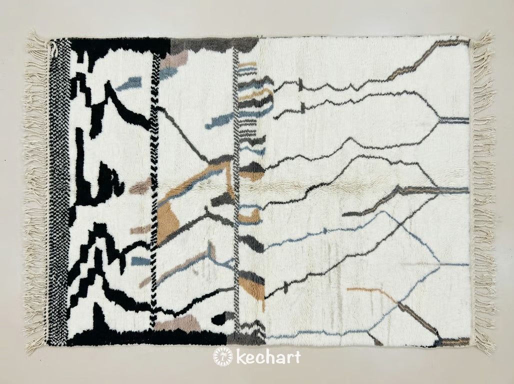 Custom made Beni Ourain Moroccan rug showing plush soft white wool pile with medium cool grey and soft taupe geometric diamond patterns and traditional fringe.