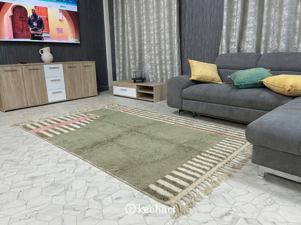 Close-up texture shot showing the thick, high pile of the natural wool fibers and the hand-knotted craftsmanship of the custom sage and pink diamond pattern.