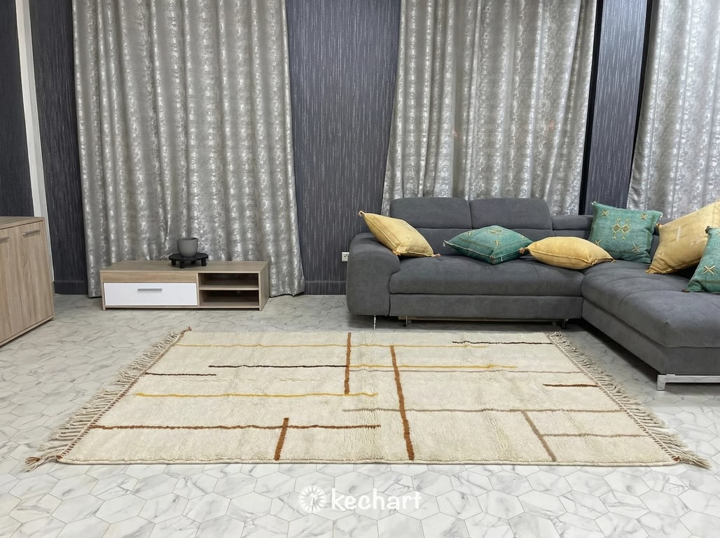 Close-up view of the thick, hand-knotted wool pile and traditional fringe of a bespoke Moroccan rug showing the rich Sierra and saffron color variations.