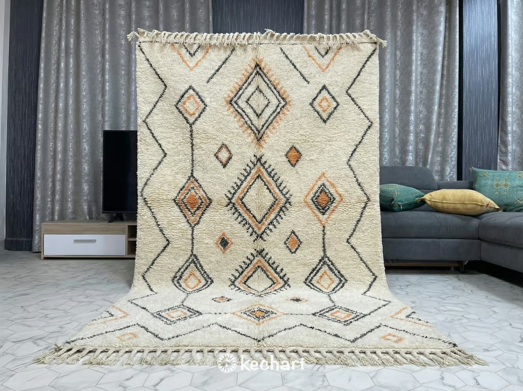 Plush Beni Ourain area rug placed under a queen bed in a bohemian style bedroom, highlighting the soft texture and warm tangerine accents.