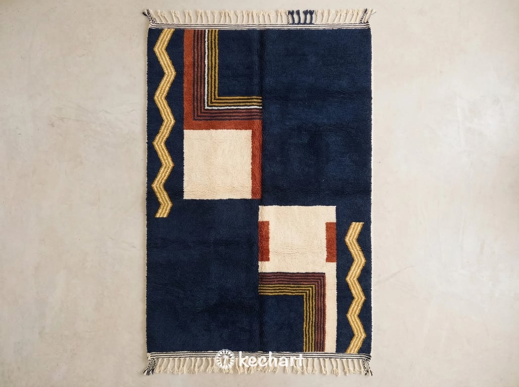 Custom made Beni Ourain Moroccan wool rug featuring plush cream pile with geometric diamond patterns rendered in rust, midnight navy, and curry yellow threads with traditional fringe.