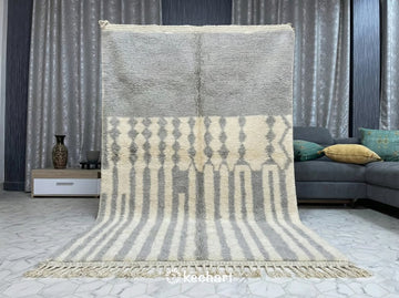 Artisan crafted Moroccan Berber rug in light grey geometric pattern styled in a bright, modern home office or quiet reading nook.
