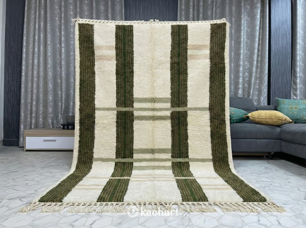 Contemporary minimalist space featuring the geometric Moroccan area rug as a focal point, contrasting earthy green colors against white walls and modern furniture.