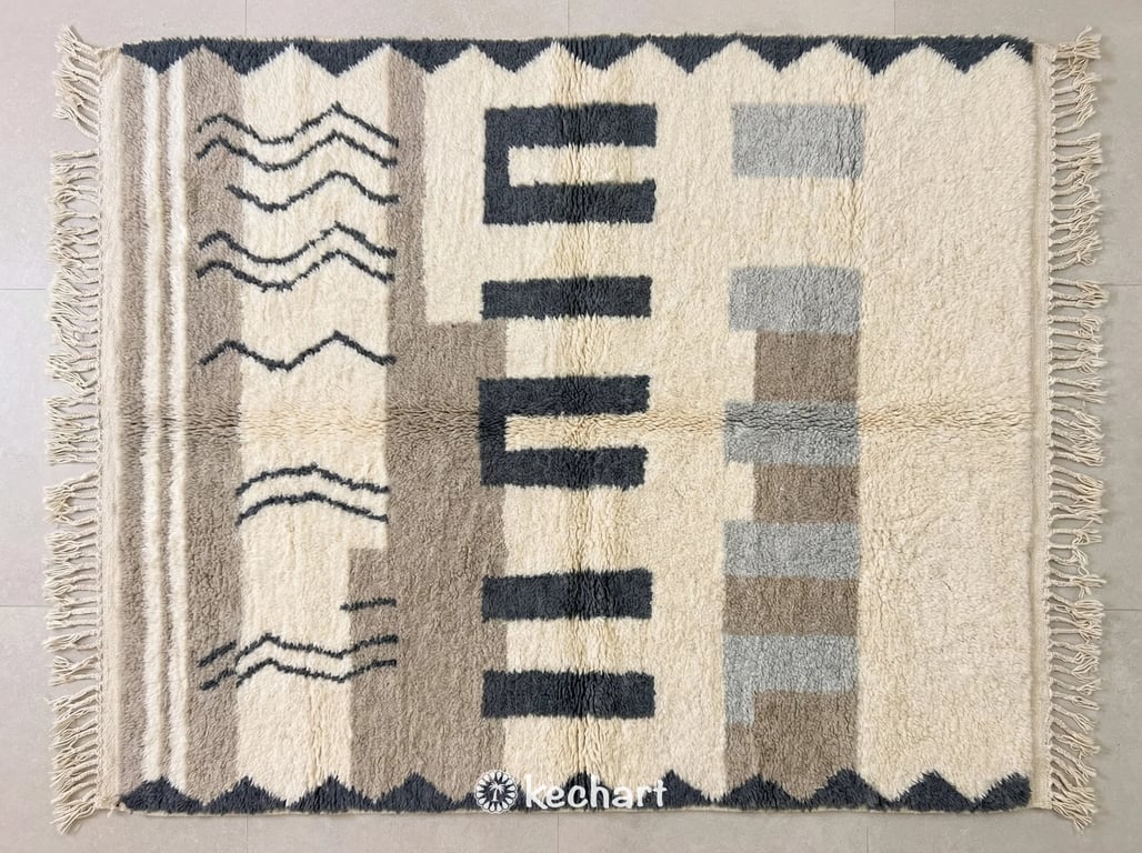 Custom made Beni Ourain Moroccan wool rug featuring a plush pile with slate grey, silver grey, and soft white geometric diamond patterns and traditional fringe. Handwoven texture visible close up.