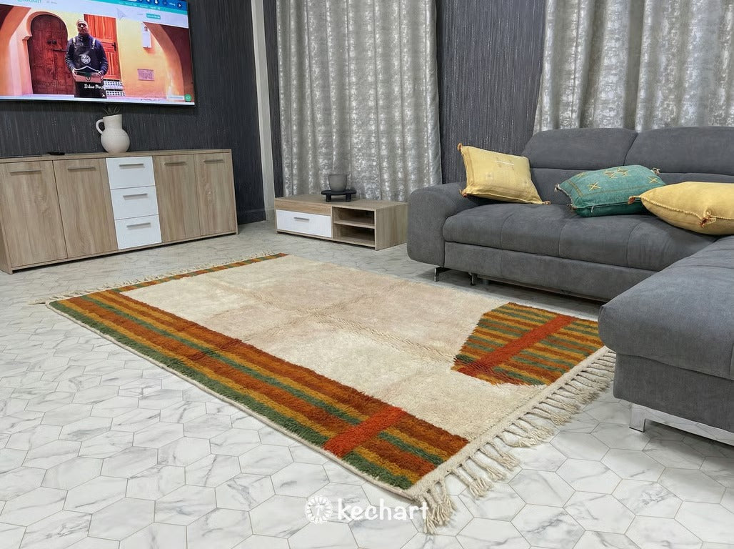 Large custom Moroccan wool rug with subtle geometric diamond pattern adding texture and warmth to a minimalist, Japandi-style living space with concrete floors.