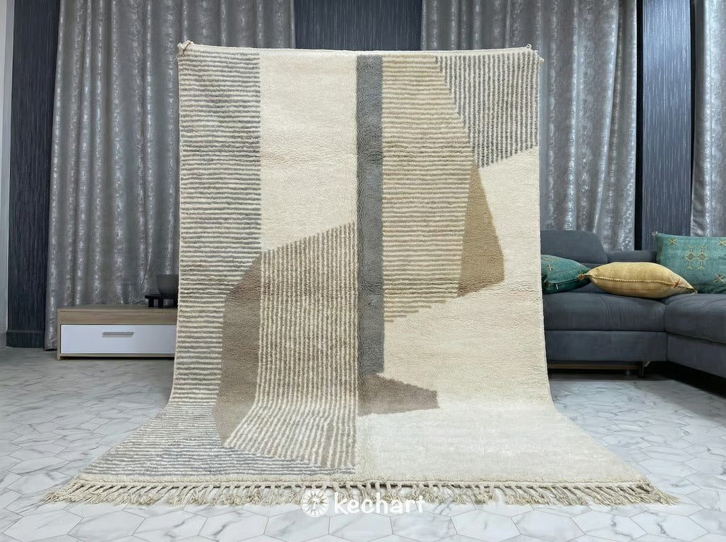 Close-up shot of handwoven Beni Ourain rug pile showing the thick, natural wool fibers in soft white, taupe, and sand colors.