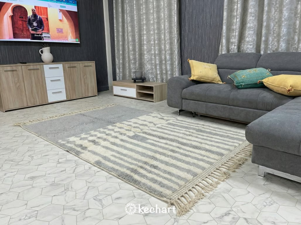 Artisan crafted Moroccan Berber rug in light grey geometric pattern styled in a bright, modern home office or quiet reading nook.