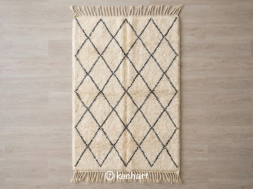 Handwoven Custom Beni Ourain Moroccan Rug with shaggy cream wool pile and charcoal imperfect diamond lattice pattern, showing traditional fringe.