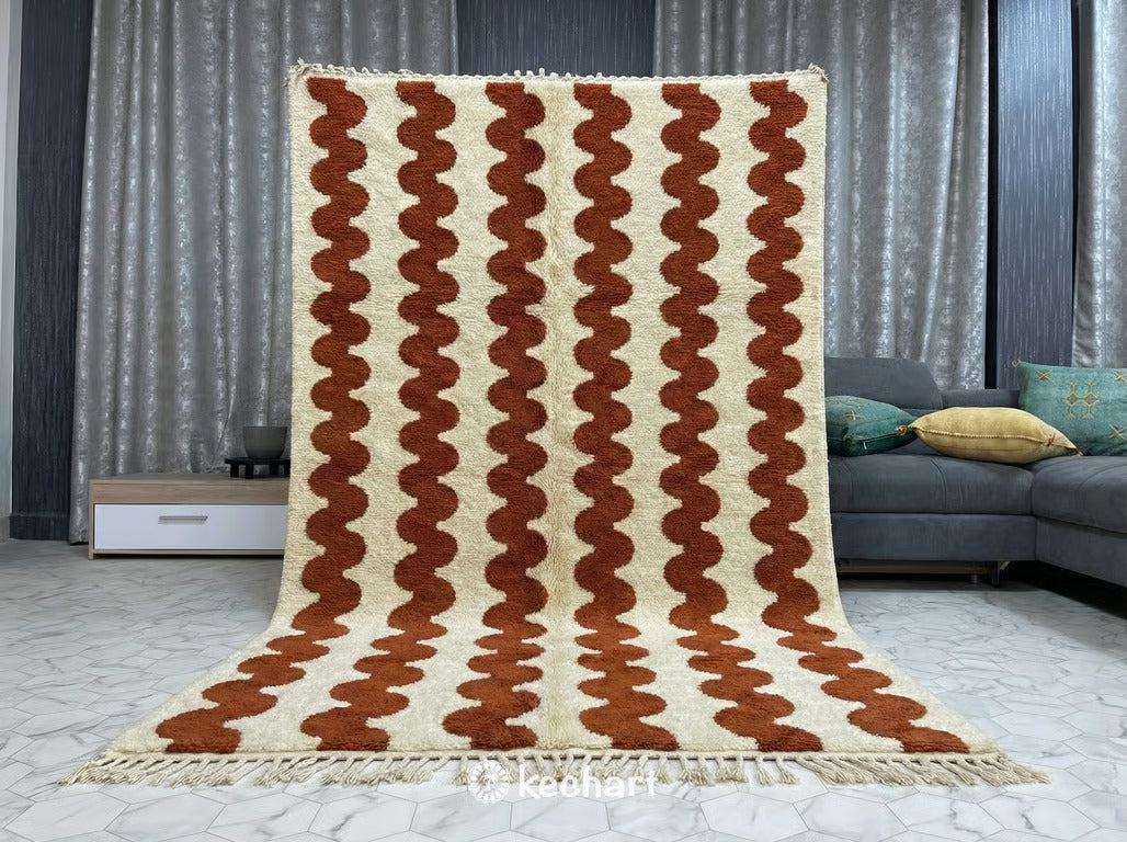 Handwoven Berber wool rug in custom size showing soft cream pile and rust geometric lattice pattern, adding warmth to a minimalist nursery or home office.