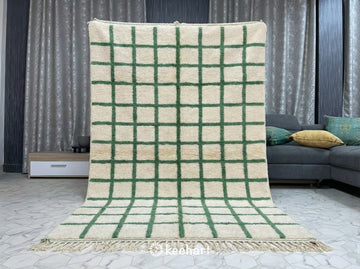 Close-up Detail of High Pile Beni Ourain Sheep's Wool Texture showing the thick Natural Cream yarns and the woven Russian Green geometric motifs.