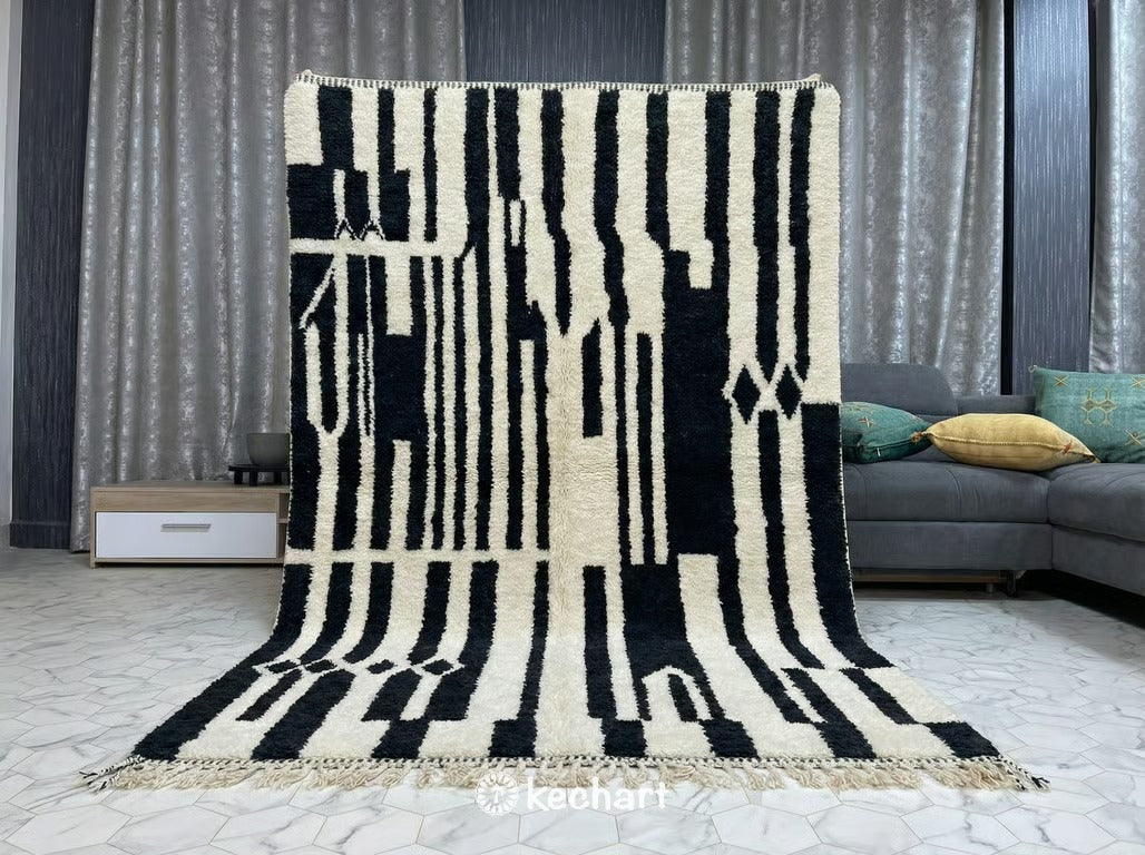 Flat lay view of Custom Beni Ourain Moroccan Wool Rug showing plush cream pile with charcoal and impala geometric diamond lattice pattern and traditional fringe.