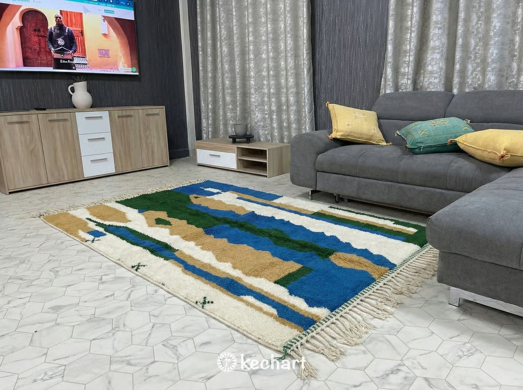 Close-up detail shot of handwoven Beni Ourain wool rug showing the thick pile texture and vibrant blue, green, and gold dyed yarns.