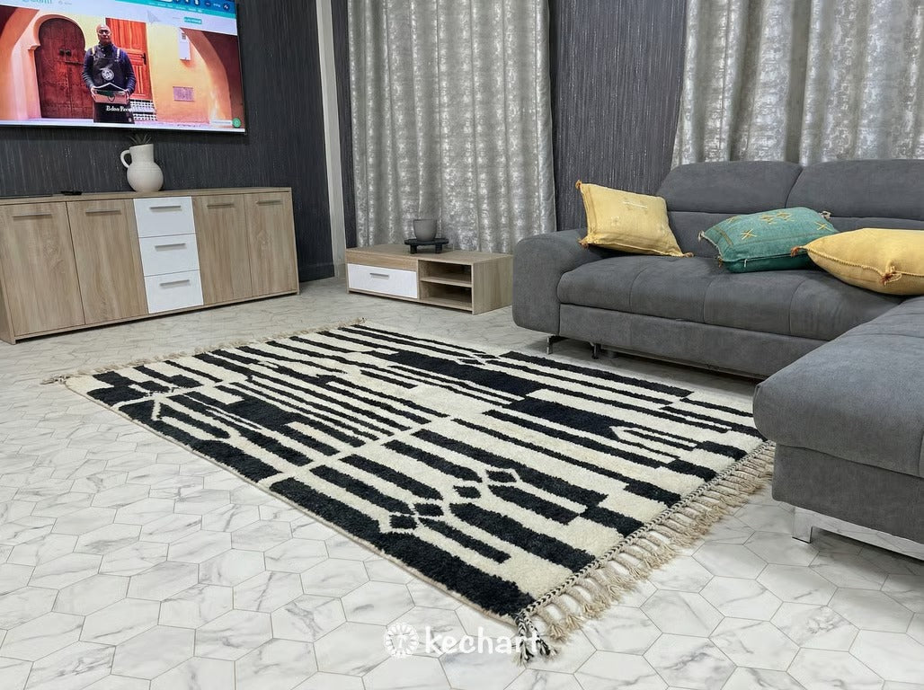 Flat lay view of Custom Beni Ourain Moroccan Wool Rug showing plush cream pile with charcoal and impala geometric diamond lattice pattern and traditional fringe.