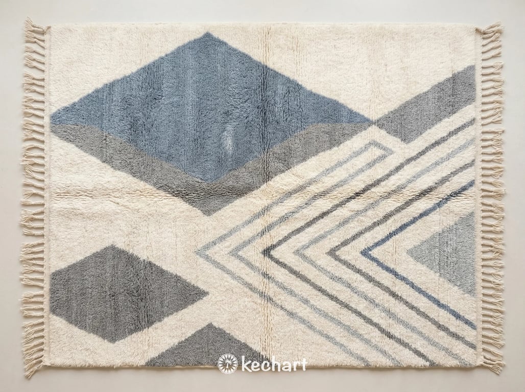 Custom made-to-order Beni Ourain Moroccan rug flat lay showing plush wool texture in dusty blue grey, medium cool grey, and light silver geometric diamond patterns.