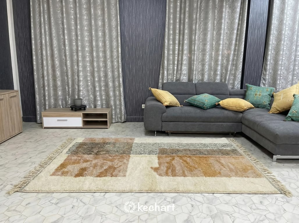 Close up detail shot of hand-knotted Moroccan rug pile showing thick wool yarn, earthy color variations, and artisan craftsmanship.