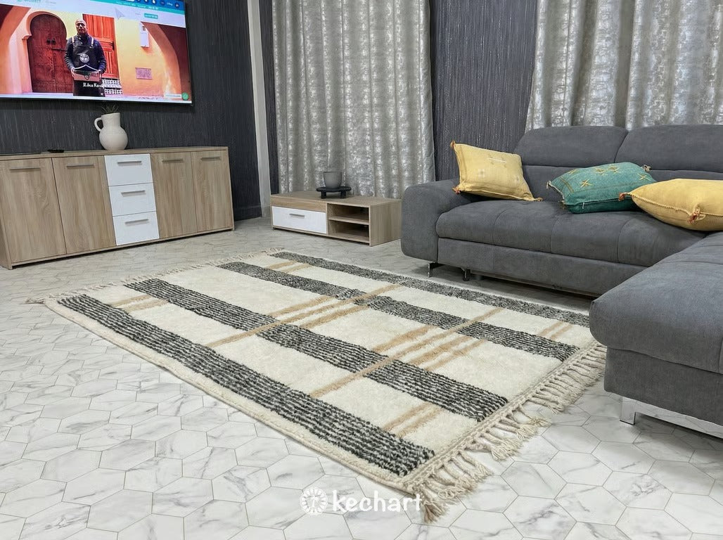 Detail shot highlighting the deep, shaggy wool pile and hand-knotted construction of the custom Moroccan rug, showing the variation in the natural soft white and greige yarn.