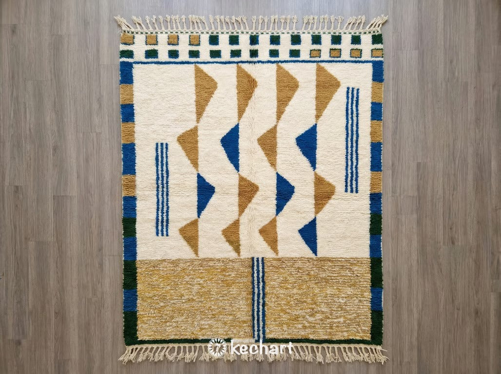 Handwoven Custom Beni Ourain Moroccan Rug featuring plush wool with geometric diamond patterns in Moroccan Blue, Aztec Gold, and Fir Green on a soft white base with traditional fringe.