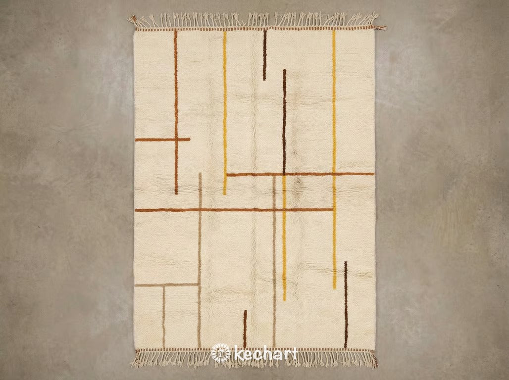 Custom made Beni Ourain Moroccan wool rug featuring a plush shag texture and geometric diamond pattern in warm earth tones of sierra, saffron, sandy beige, and leather brown with traditional fringe.