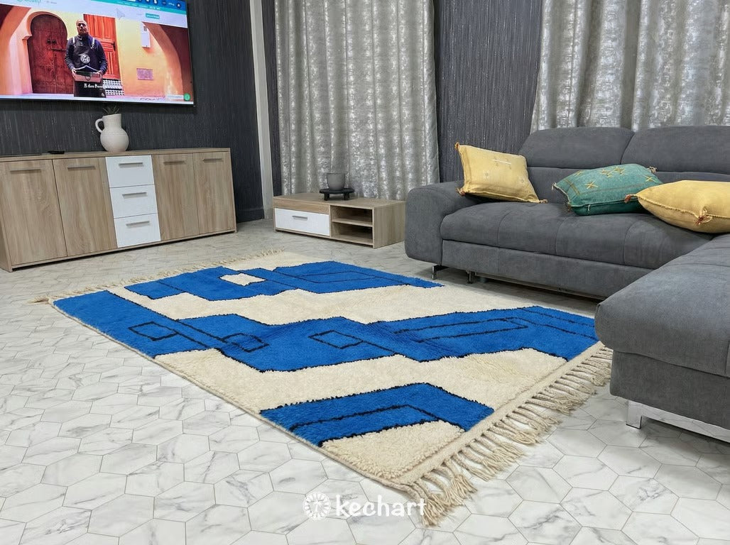 Detail shot of the high-pile wool texture and hand-knotted fringe of a bespoke Azur blue and cream Moroccan rug in a minimalist hallway.