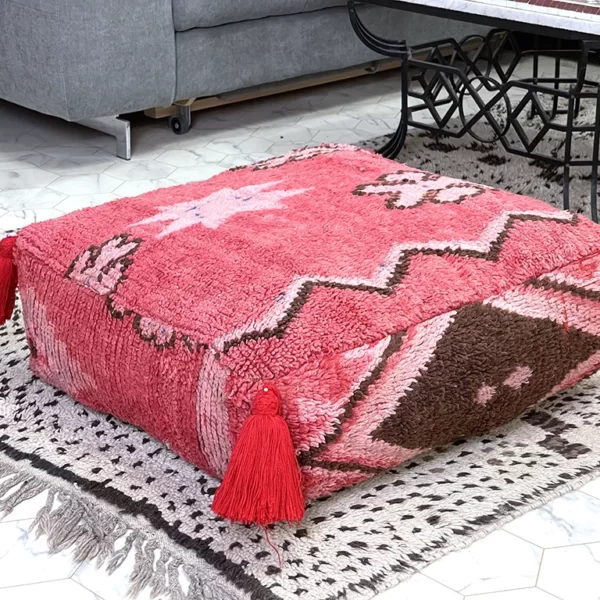 Upgrade your home decor with the Jardin Rouge Kilim Pouf, inspired by the passion and creativity of the Jardin Rouge art center. Handmade in Morocco, this versatile and stylish ottoman features bold red tones, perfect for adding a touch of artistic flair to any space.